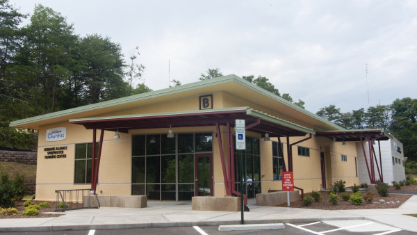 A building with a parking lot in front of it.