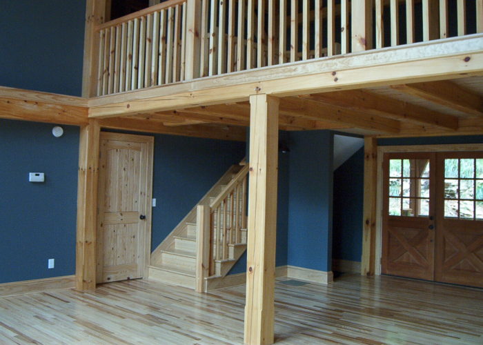 A large open room with wooden floors and stairs.