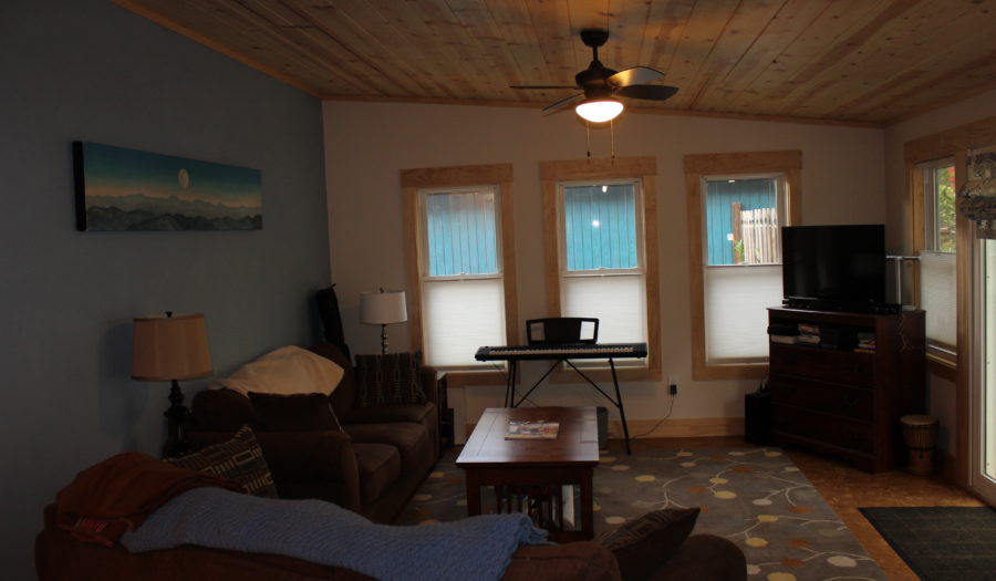 A living room with two windows and a couch